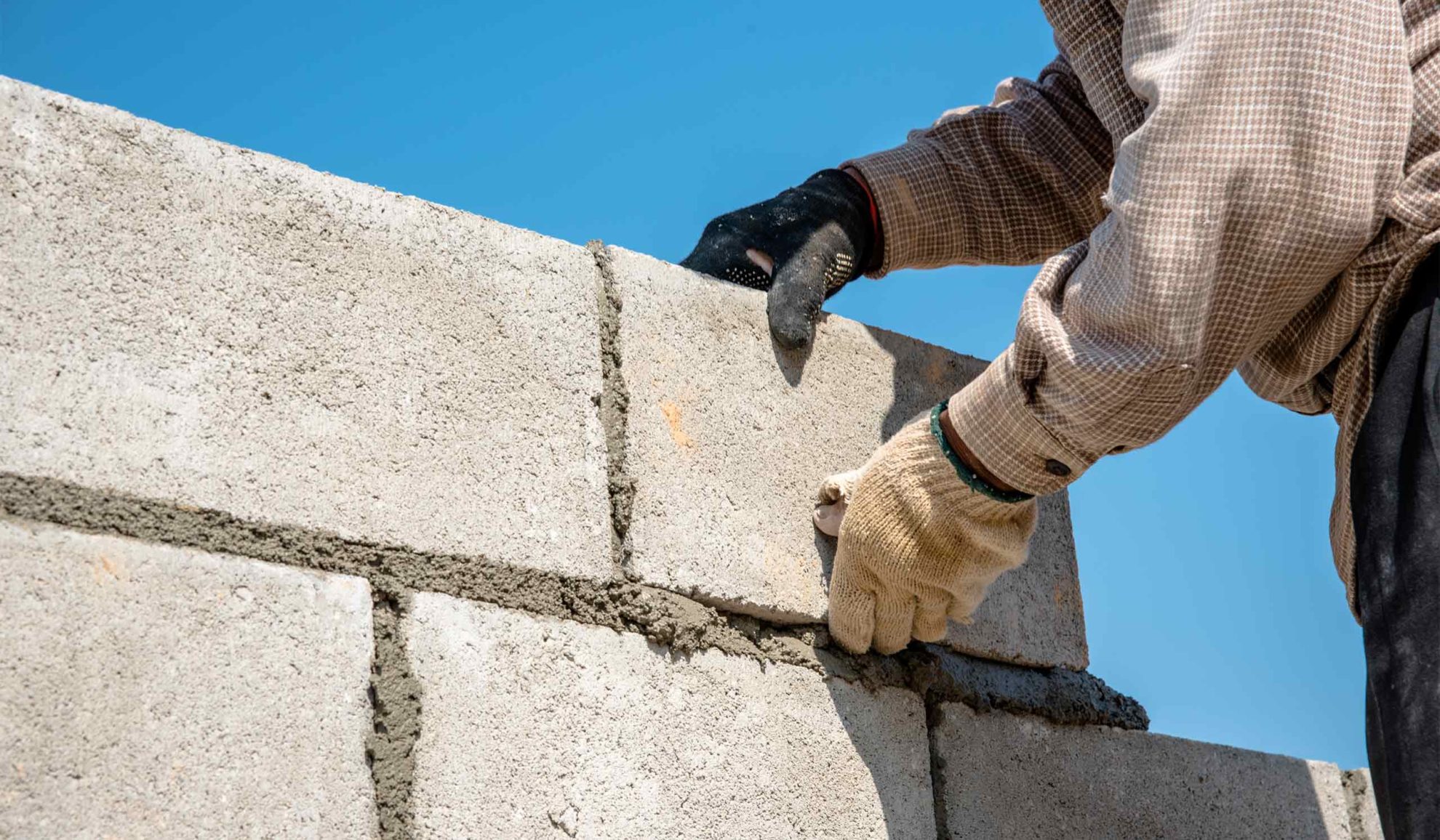 contractor with construction gloves building a concrete bricks wall blue ridge mo
